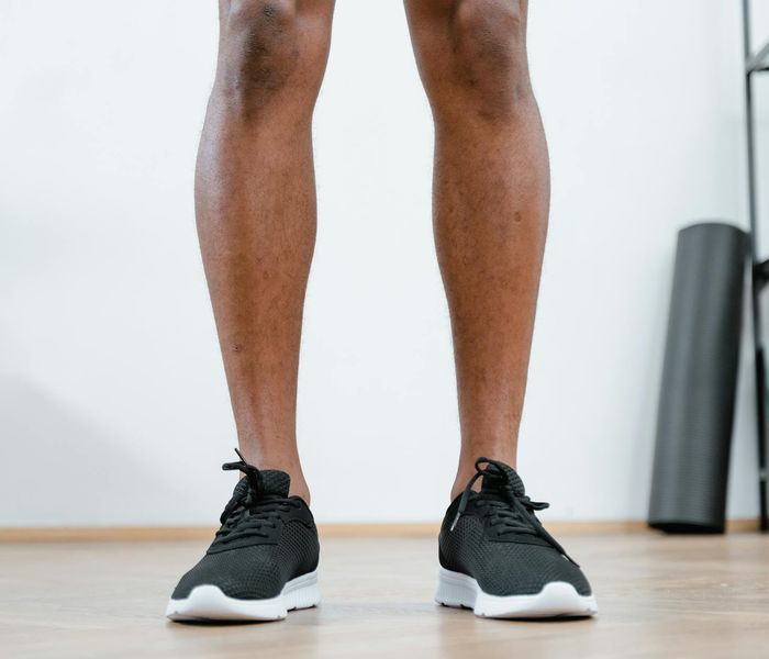 Close up of athletic shoes on a wooden floor in a gym.