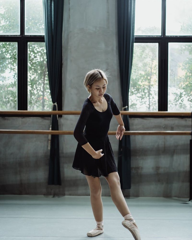 Young woman practicing gentle cardio movements in a warm studio.